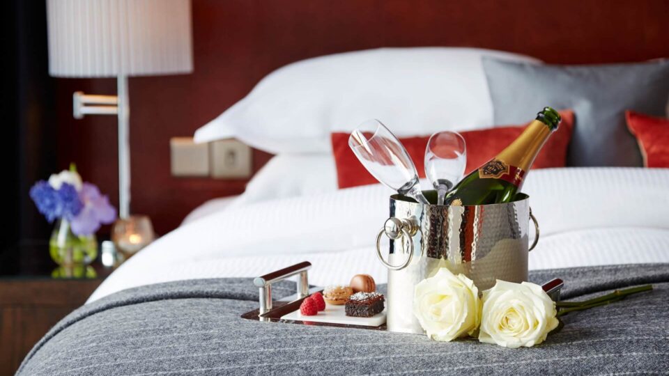 champagne bottle on a bed